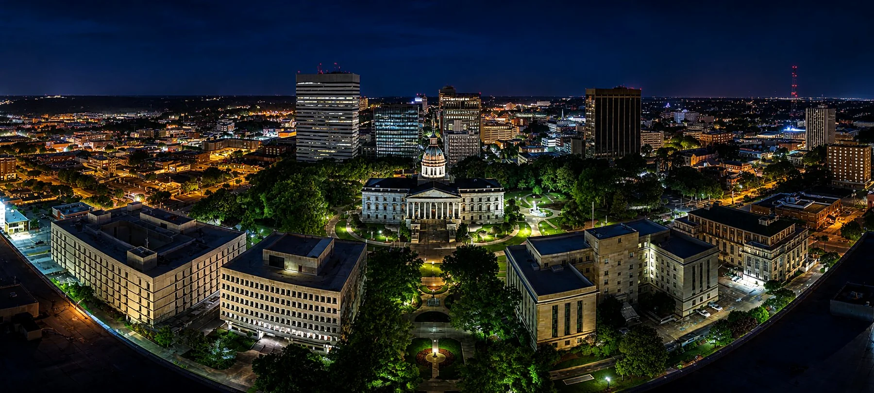 Aerial view of the South Carolina State House and Columbia skyline at night